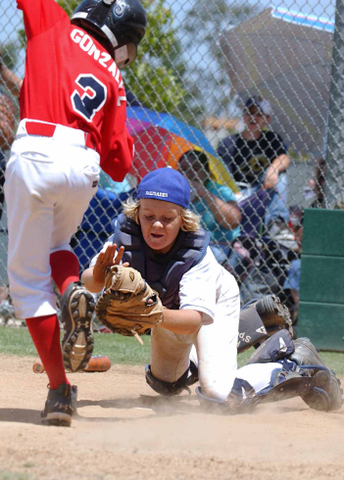 Palisades catcher Paul Kirkpatrick lunges to tag a Pico Rivera runner at home plate in Saturday's Mustang All-Star game at the Field of Dreams.